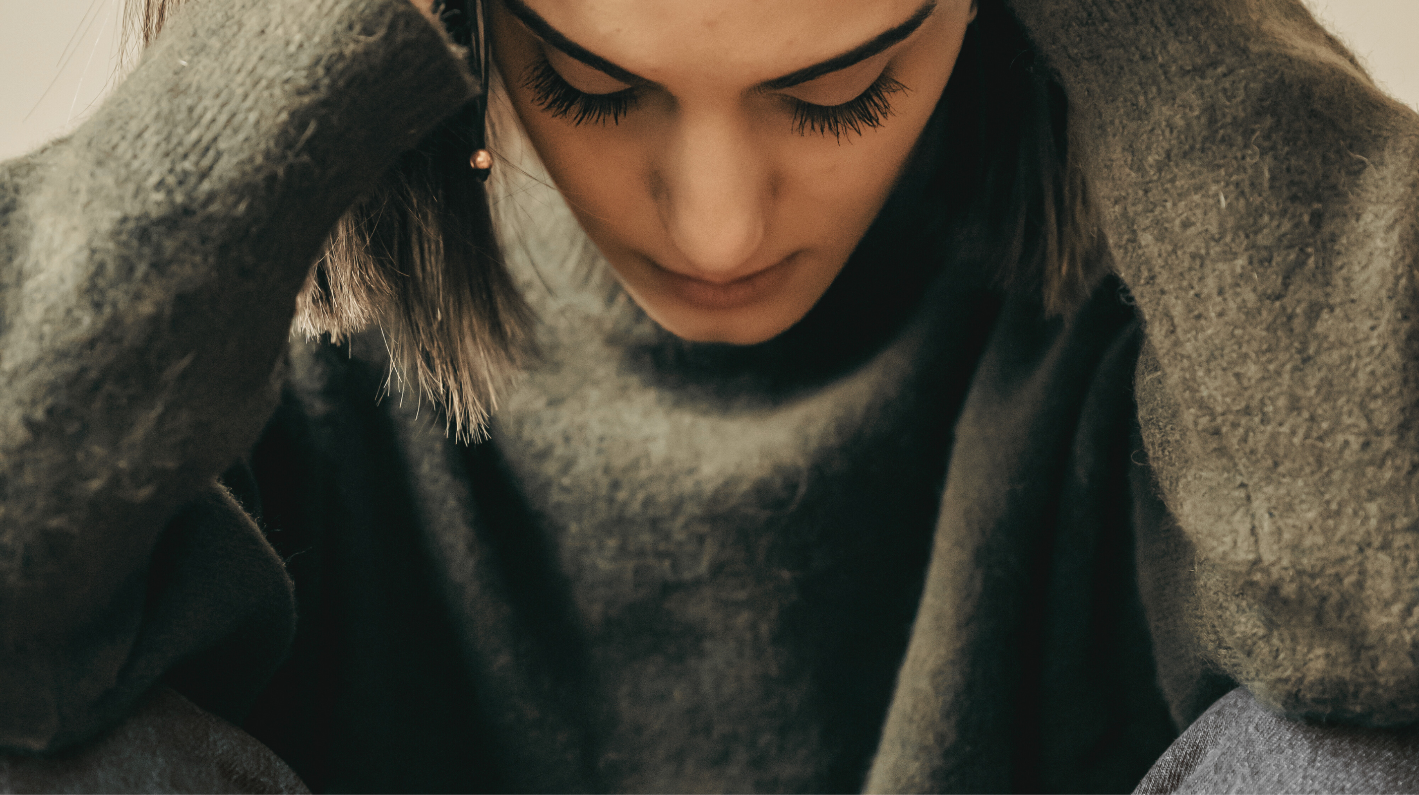 woman sitting with head in hands